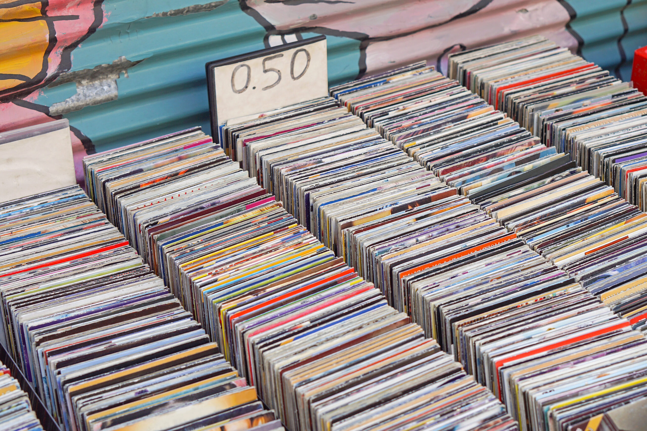 Used CDs for sale at a flea market with Luxline graphic packaging • Solidus